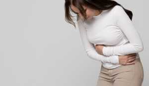 PCOS: Polycystic Ovarian Syndrome - woman holding stomach